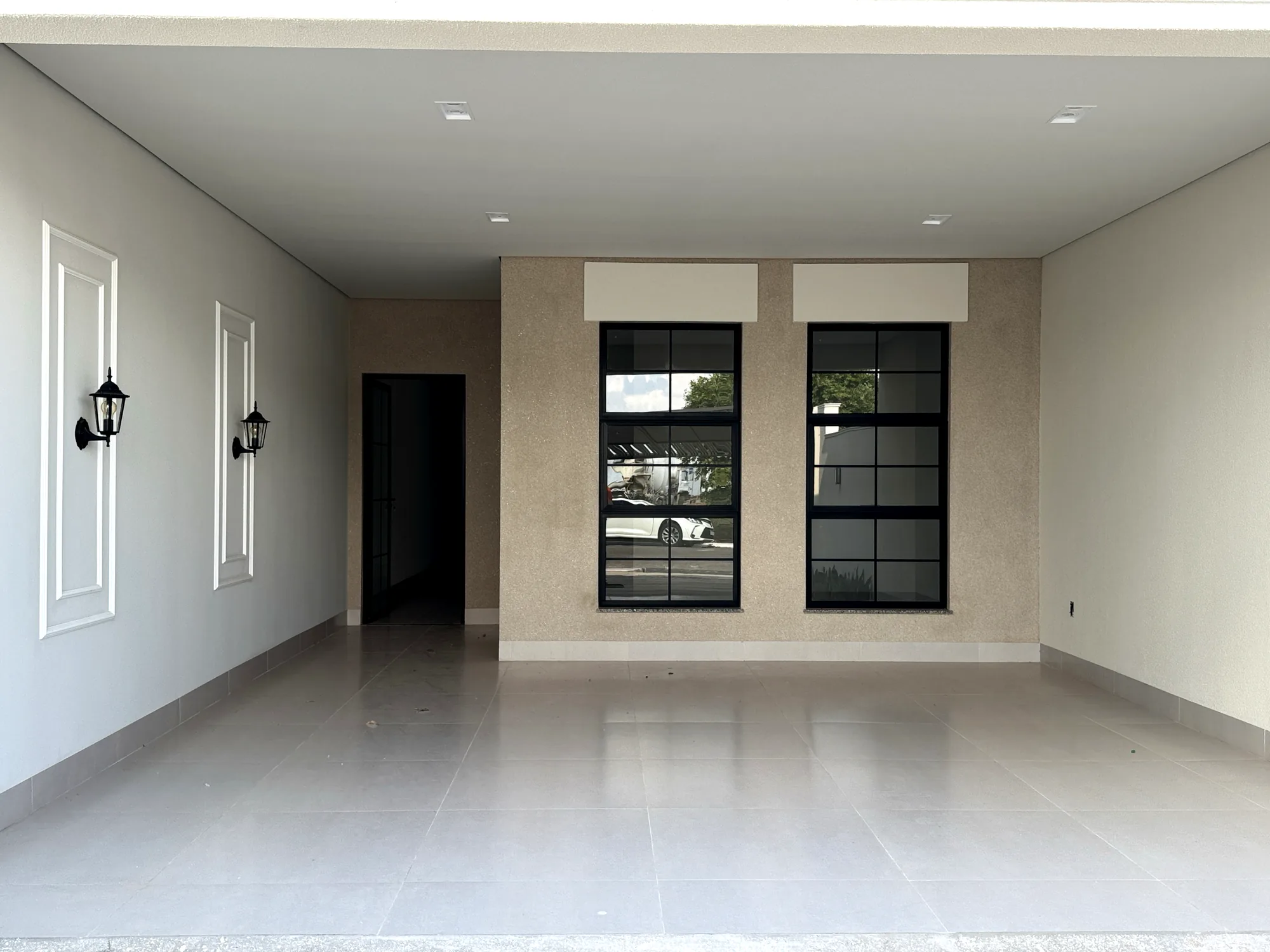 Garagem coberta com a fachada da sala