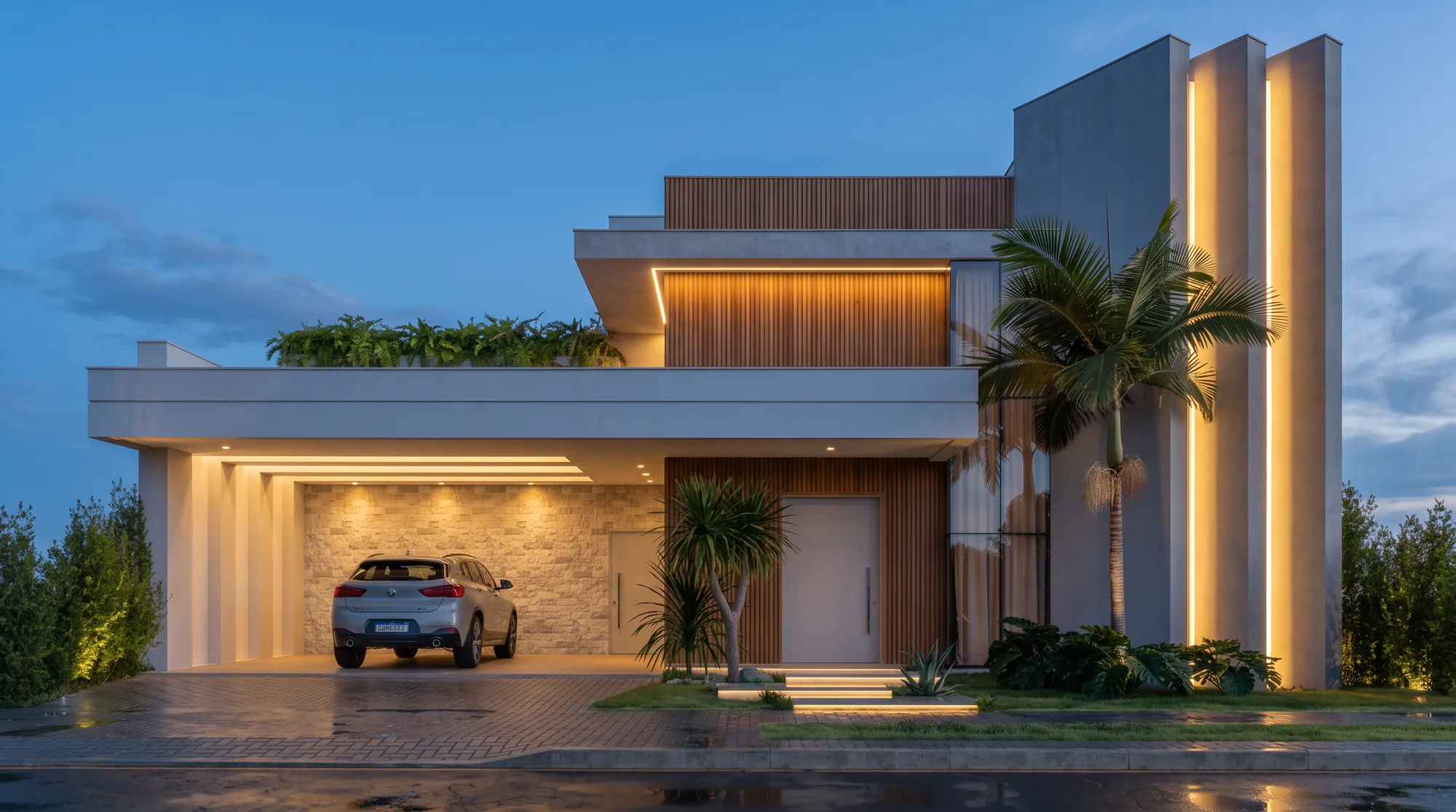 Sobrado moderno branco à noite, com garagem iluminada e jardim na laje